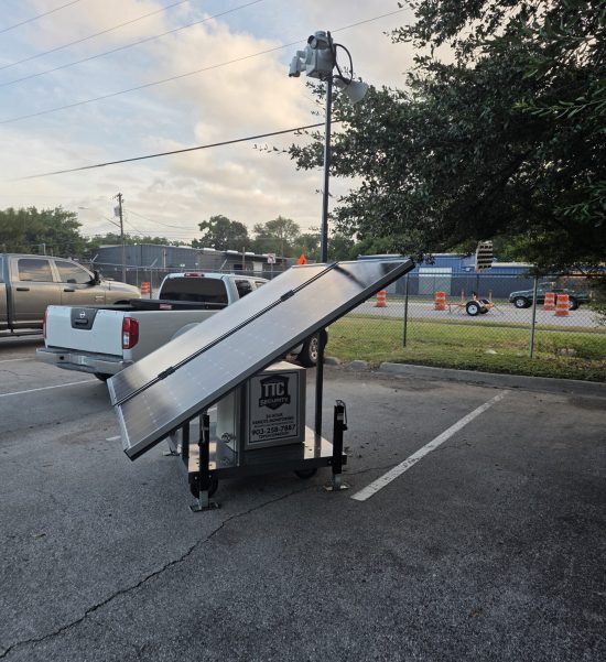 Mobile solar-powered security camera trailer providing 24/7 remote surveillance for a commercial property in Austin, Texas.